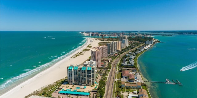 bird's eye view featuring a water view and a beach view