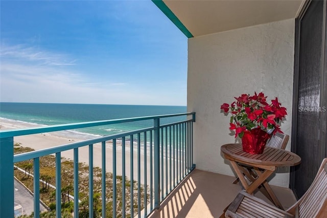 balcony with a beach view and a water view