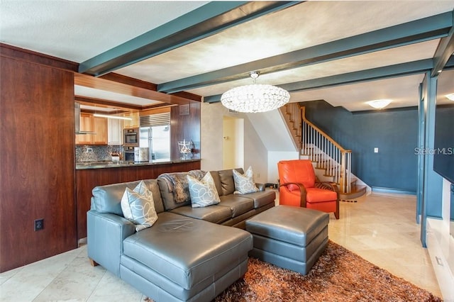 living room featuring beam ceiling and an inviting chandelier