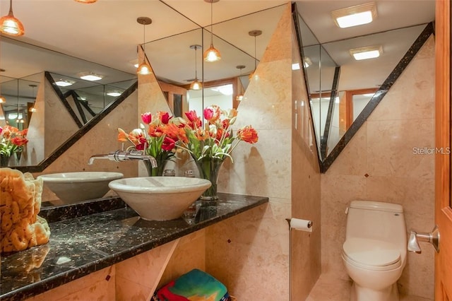 bathroom with tile walls and sink