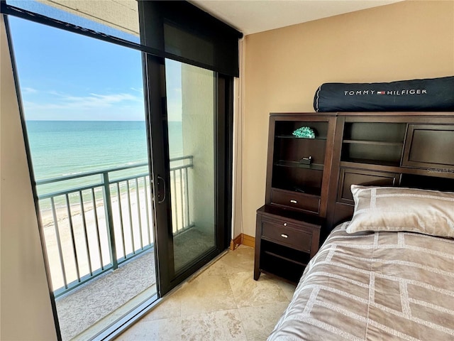 bedroom with a water view and a beach view