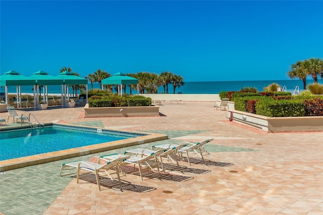 view of pool with a patio area, a gazebo, and a water view