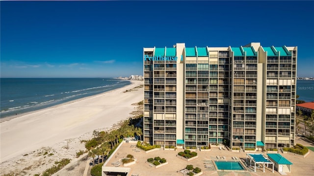 view of property featuring a water view and a view of the beach