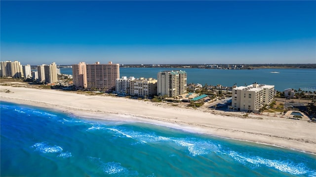 drone / aerial view with a water view and a view of the beach