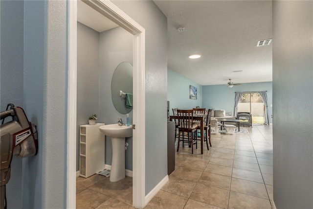 bathroom featuring tile patterned floors, ceiling fan, and sink