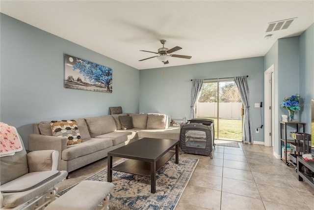 tiled living room with ceiling fan