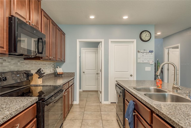 kitchen featuring decorative backsplash, a textured ceiling, sink, black appliances, and light tile patterned floors