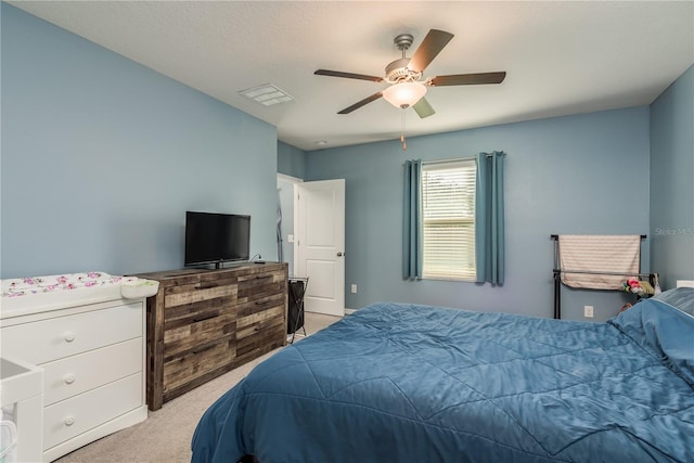 bedroom with ceiling fan and light carpet