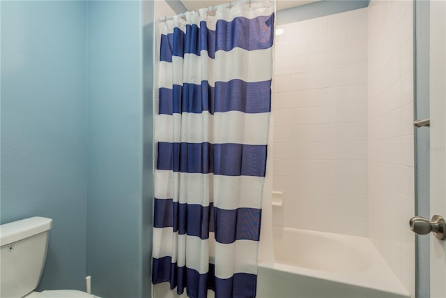 bathroom with toilet and shower / tub combo with curtain