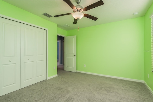 unfurnished bedroom featuring light colored carpet, a closet, and ceiling fan