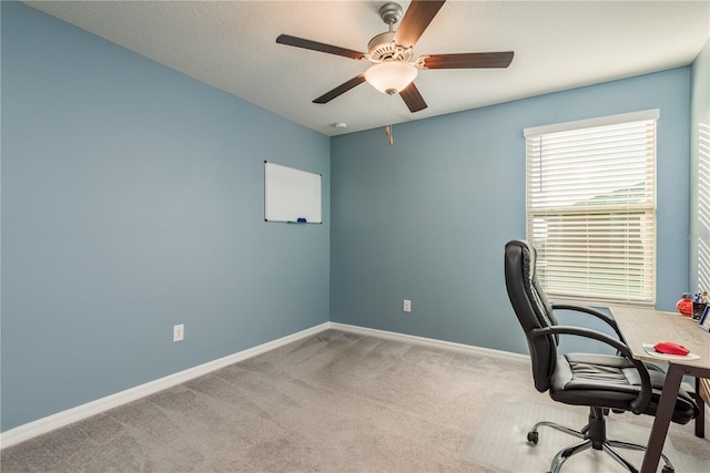 office area featuring light carpet and ceiling fan