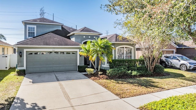 front of property featuring a front yard and a garage