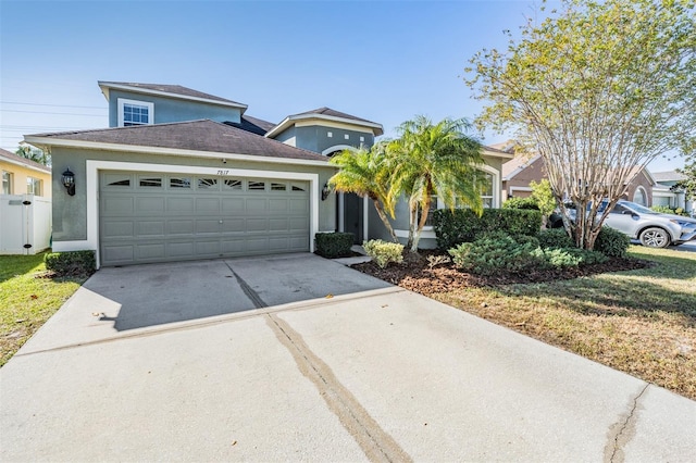 view of front of home featuring a garage and a front lawn