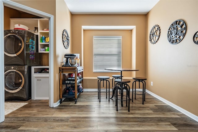 dining room featuring stacked washer and clothes dryer and hardwood / wood-style flooring