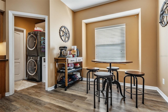 dining room with stacked washer / dryer and hardwood / wood-style floors