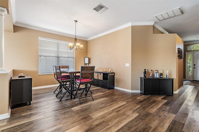 dining room featuring dark hardwood / wood-style flooring, a chandelier, and ornamental molding