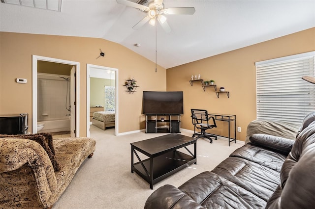 carpeted living room with ceiling fan and lofted ceiling