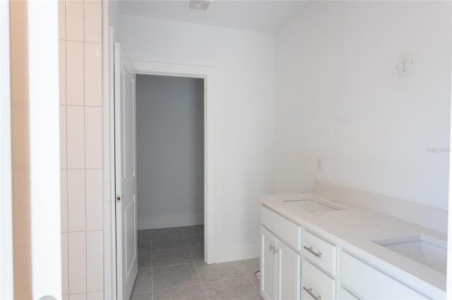 bathroom with tile patterned floors and vanity