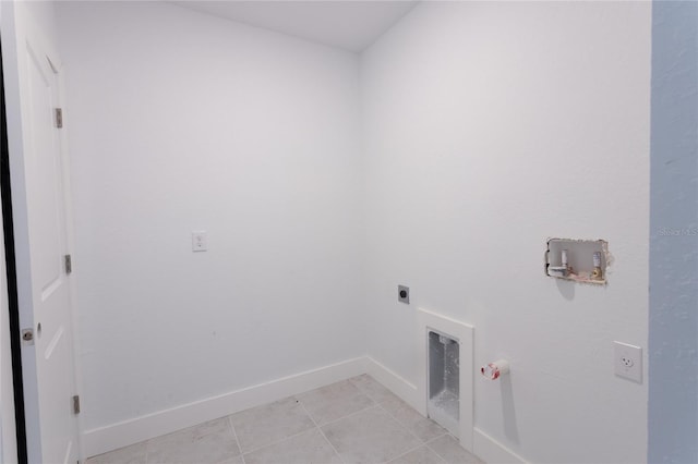 clothes washing area with electric dryer hookup, gas dryer hookup, and light tile patterned floors