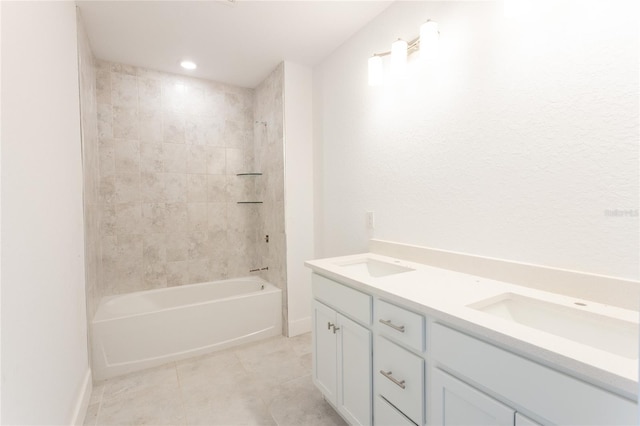 bathroom featuring vanity, tiled shower / bath combo, and tile patterned flooring