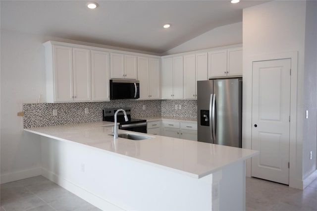 kitchen with stainless steel appliances, white cabinetry, and kitchen peninsula