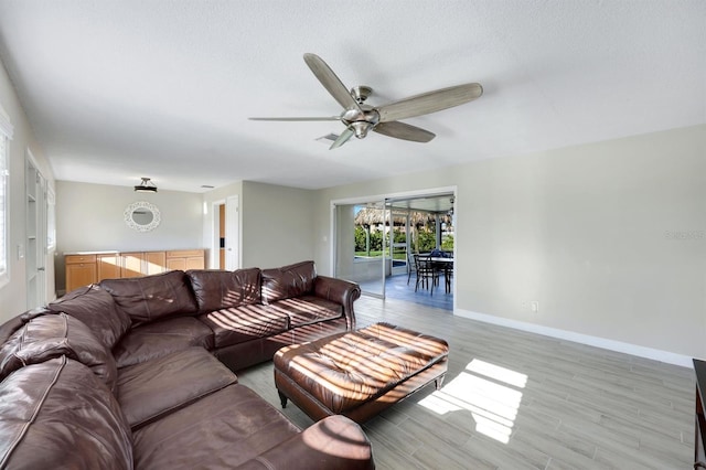 living room featuring ceiling fan and light hardwood / wood-style floors