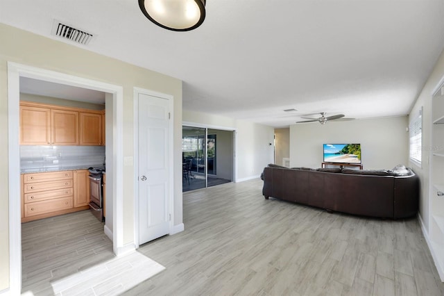 living room featuring light wood-type flooring and ceiling fan