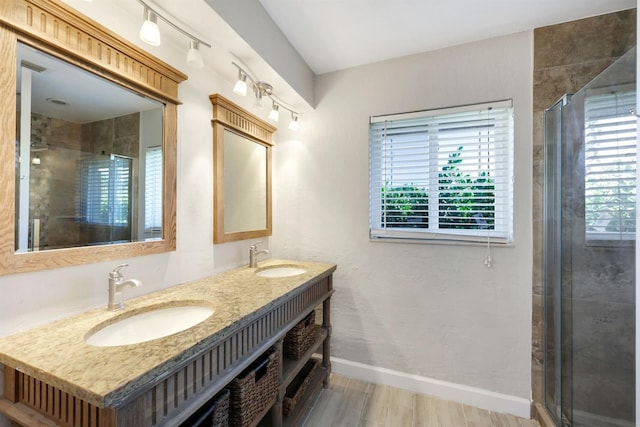 bathroom with vanity, hardwood / wood-style flooring, and walk in shower