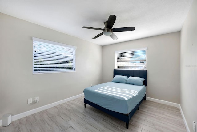 bedroom with ceiling fan and light hardwood / wood-style floors