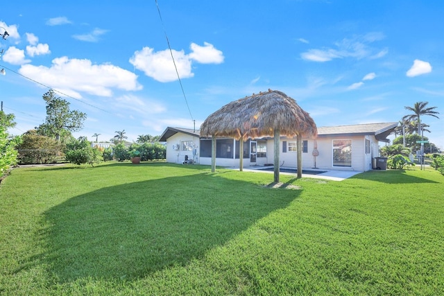 rear view of property with a lawn and a patio