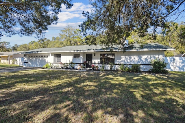 single story home featuring a garage and a front lawn