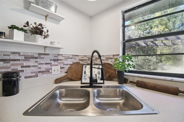 details featuring decorative backsplash and sink