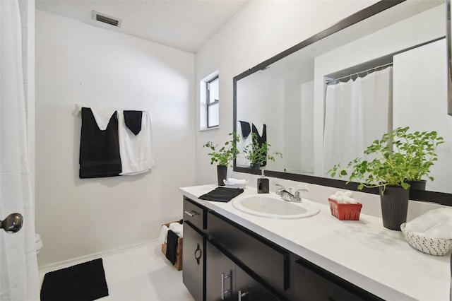 bathroom featuring vanity and a textured ceiling