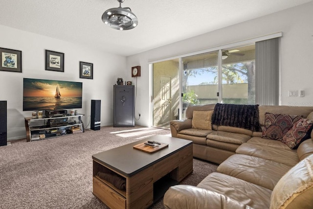 carpeted living room featuring ceiling fan and a textured ceiling