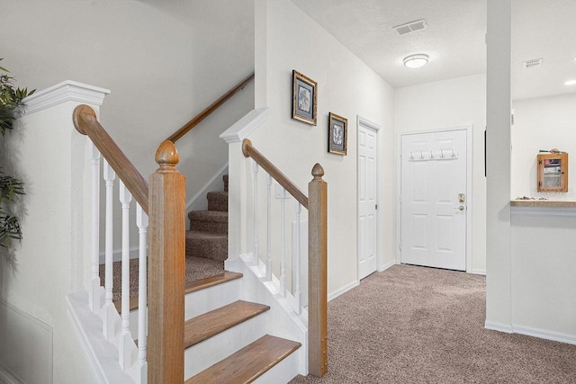 view of carpeted foyer