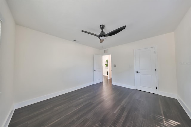 unfurnished room featuring ceiling fan and dark wood-type flooring