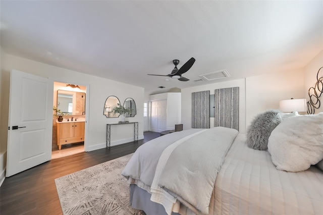 bedroom with connected bathroom, dark hardwood / wood-style floors, and ceiling fan