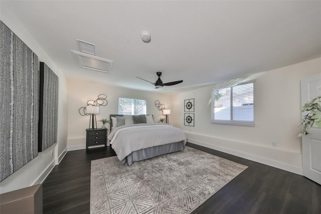 bedroom featuring hardwood / wood-style flooring, ceiling fan, and multiple windows