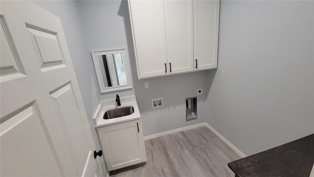 clothes washing area featuring cabinets, sink, hookup for a washing machine, hookup for an electric dryer, and light hardwood / wood-style floors