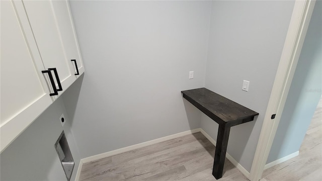 laundry area with light wood-type flooring