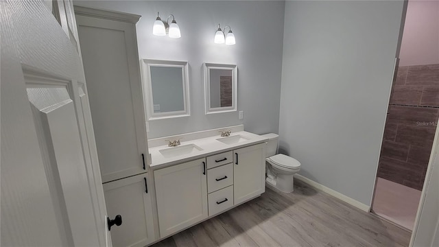 bathroom featuring hardwood / wood-style floors, vanity, and toilet