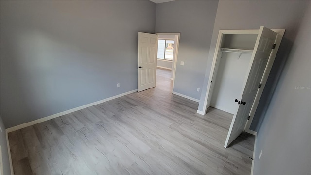 unfurnished bedroom with light hardwood / wood-style floors and a closet