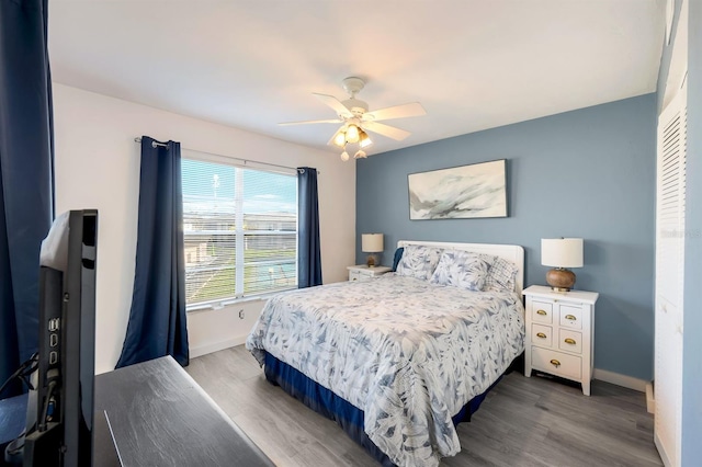 bedroom with hardwood / wood-style floors and ceiling fan