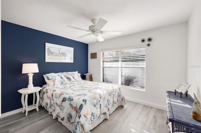 bedroom with ceiling fan and light hardwood / wood-style floors