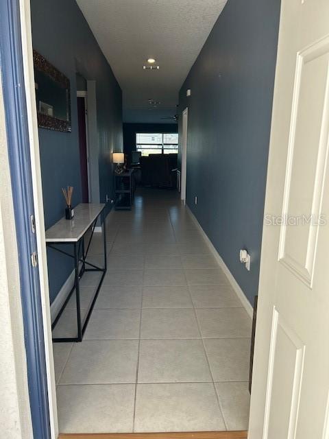 hallway with light tile patterned floors