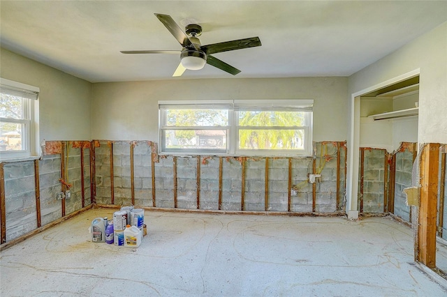 interior space with ceiling fan