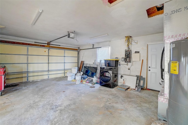 garage featuring a garage door opener and washer / dryer