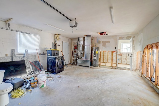 garage with separate washer and dryer, a garage door opener, and water heater