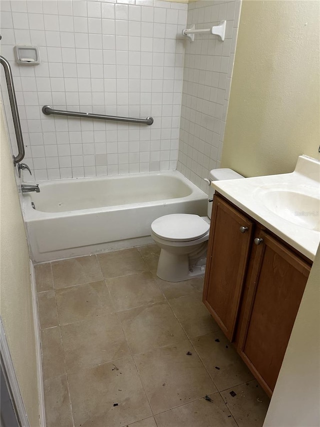 full bathroom with tile patterned flooring, vanity, toilet, and tiled shower / bath