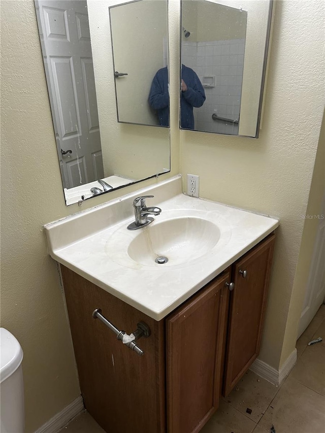 bathroom featuring toilet, vanity, and tile patterned floors